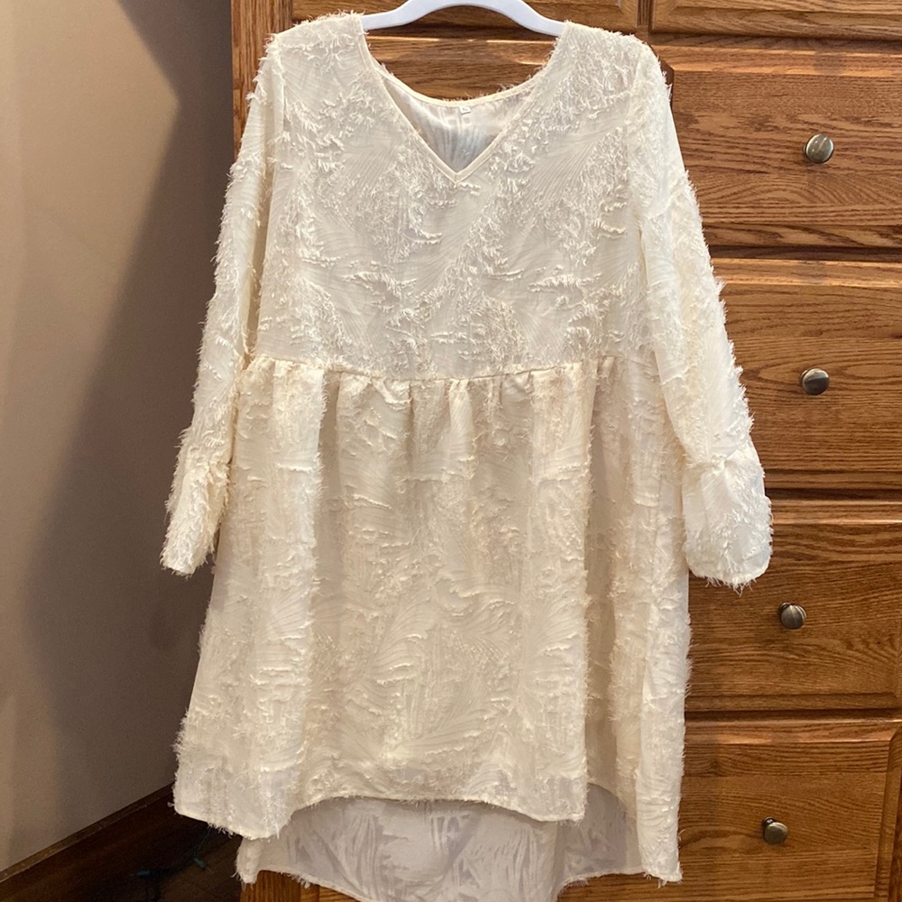 Never worn ladies size small baby doll dress with high low bottom, cream color